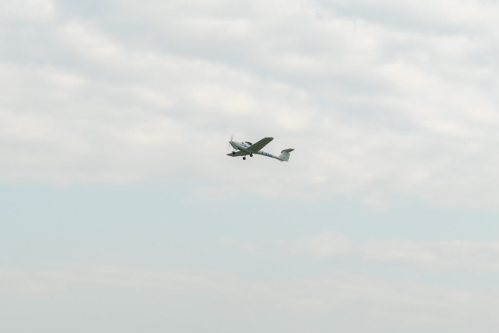 Single‑engine training aircraft flying in the sky

