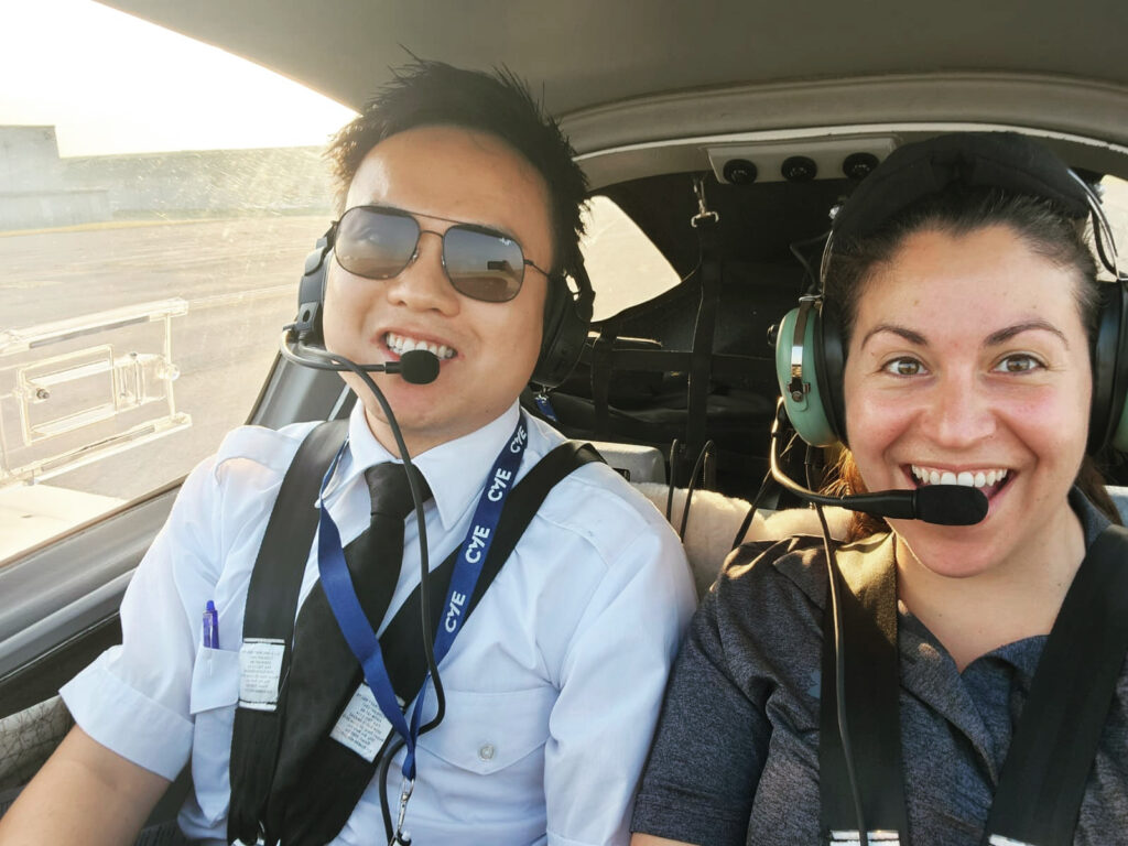 Two pilot trainees seated in a small aircraft cockpit during flight training

